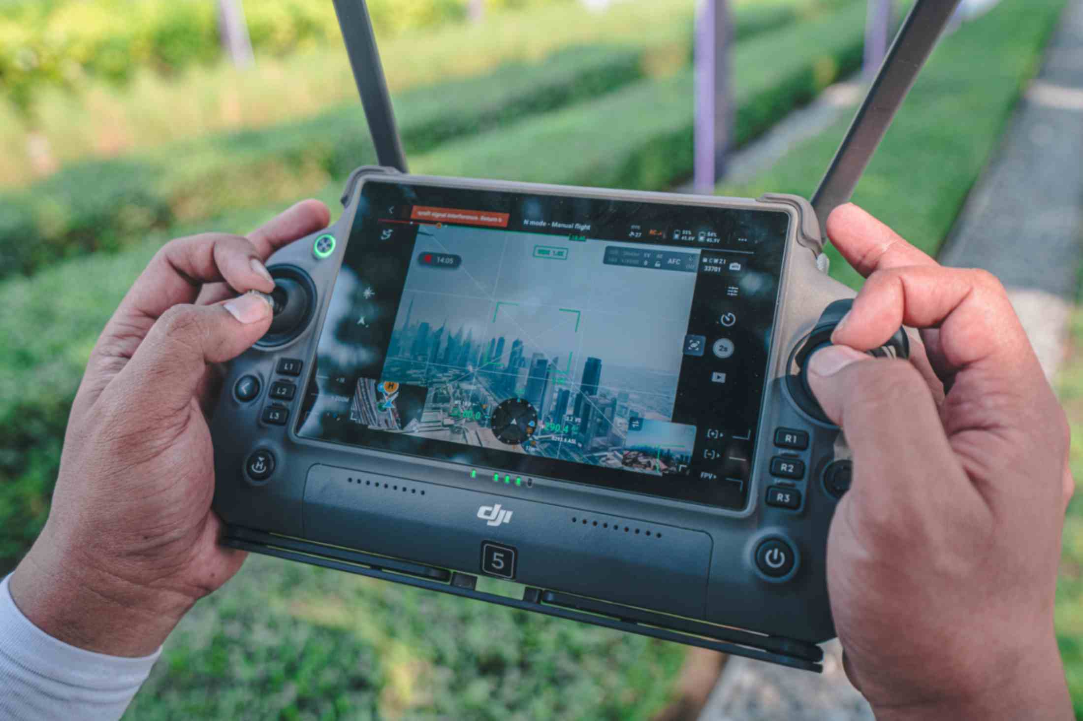 A drone controller with drone's POV during a mission